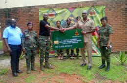 Brigadier General Dr. Kingsley Magomero receives the symbolic cheque from Msilikali SACCO
